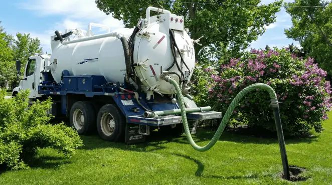 Professional vacuum truck performing residential drainage and septic maintenance in Nashua, NH
